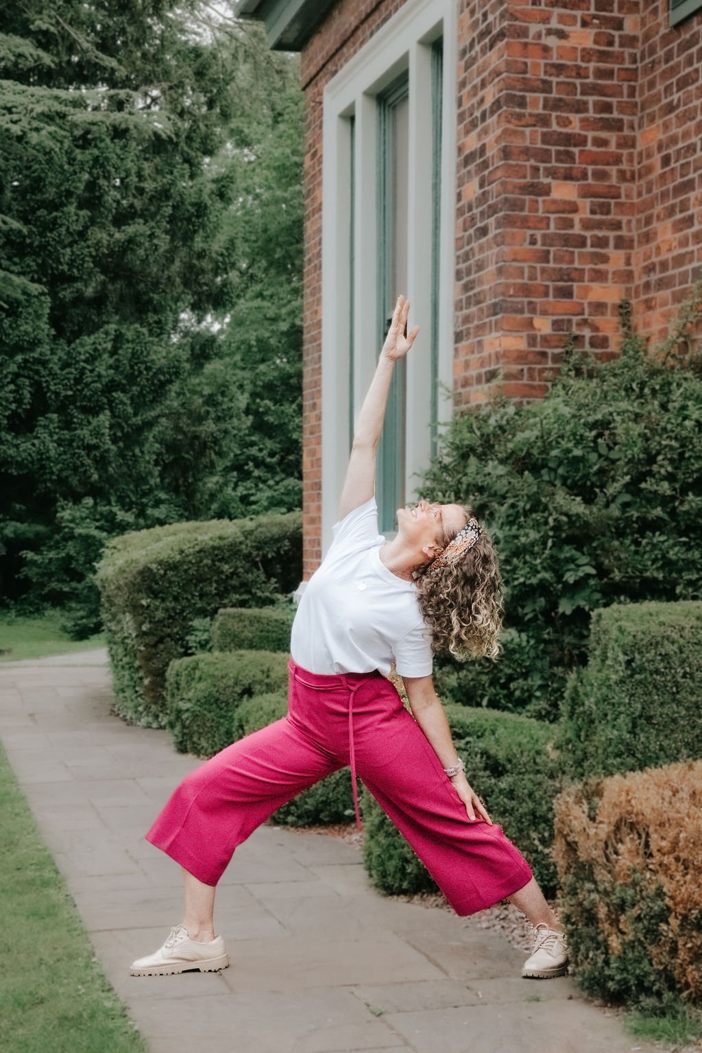 Image showing woman in office wear doing a yoga pose to promote yoga for workplaces and wellbeing